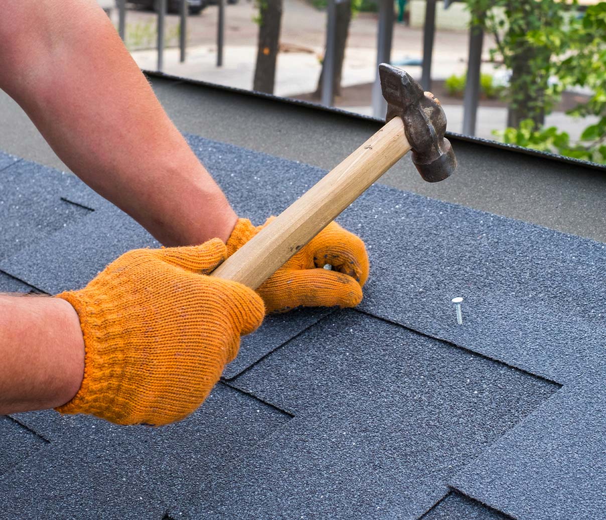 Roofer repairing roof top