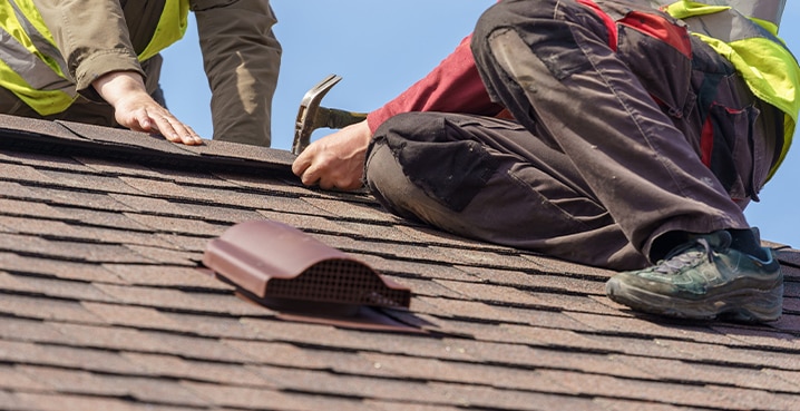 Two-roofers-on-roof-for-hail-damage-roofing-contractors Two roofers repairing roof for hail damage roofing contractors